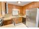 Traditional kitchen featuring wood cabinets, stainless steel appliances, and laminate countertops at 402 Princeton Way, Lawrenceville, GA 30044