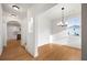 Bright dining area with hardwood floors, modern chandelier, and large window overlooking the yard at 4095 Oriole Ln, Fairburn, GA 30213