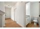 Hallway leading to the front door and a half bath with granite counters at 4095 Oriole Ln, Fairburn, GA 30213