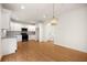 Open concept kitchen with stainless steel appliances, white cabinets, granite countertops, and decorative pendant lighting at 4095 Oriole Ln, Fairburn, GA 30213