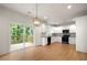 Bright kitchen features white cabinets, granite countertops, and stainless-steel appliances, leading to an outdoor deck at 4095 Oriole Ln, Fairburn, GA 30213