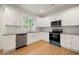Modern kitchen with stainless steel appliances, white cabinets, and granite countertops at 4095 Oriole Ln, Fairburn, GA 30213