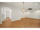 Bright and airy living room features an open layout, contemporary light fixture, and an adjacent hallway at 4095 Oriole Ln, Fairburn, GA 30213