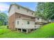A two-story home featuring a brick and siding exterior with a walk-out deck and lush greenery at 574 Hickory Hills Ct, Stone Mountain, GA 30083