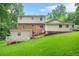 View of the back of the home, showcasing the siding and brick exterior and expansive lawn at 574 Hickory Hills Ct, Stone Mountain, GA 30083