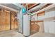 This basement has a water heater, exposed ceiling, and wooden storage shelves at 574 Hickory Hills Ct, Stone Mountain, GA 30083