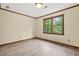 Cozy bedroom with refinished wood trim, fresh paint, new floors, and large window at 574 Hickory Hills Ct, Stone Mountain, GA 30083