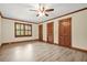 Bright bedroom features neutral walls, hardwood trim, ceiling fan, and shuttered windows at 574 Hickory Hills Ct, Stone Mountain, GA 30083