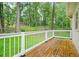 A back deck that is made of wood with a white railing at 574 Hickory Hills Ct, Stone Mountain, GA 30083