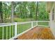 A back deck that is made of wood with a white railing at 574 Hickory Hills Ct, Stone Mountain, GA 30083