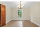 Bright dining room features new floors, fresh paint, and modern light fixture at 574 Hickory Hills Ct, Stone Mountain, GA 30083