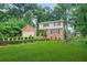 Beautifully landscaped front yard with lush green grass enhancing this lovely two-story brick house at 574 Hickory Hills Ct, Stone Mountain, GA 30083