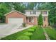 Charming two-story brick home featuring a well-manicured lawn and inviting front porch at 574 Hickory Hills Ct, Stone Mountain, GA 30083