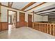 Open floor plan hallway featuring hard floors, beamed ceilings, and natural wood doors at 574 Hickory Hills Ct, Stone Mountain, GA 30083