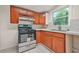 Traditional kitchen featuring wood cabinets, stainless steel range, and natural light at 574 Hickory Hills Ct, Stone Mountain, GA 30083