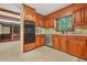A kitchen with wooden cabinetry, stainless steel appliances, and granite countertops at 574 Hickory Hills Ct, Stone Mountain, GA 30083