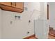 Laundry room featuring a white sink, cabinet, hardware, and shelving at 574 Hickory Hills Ct, Stone Mountain, GA 30083