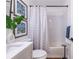 Well-lit bathroom featuring white subway tile in the shower, modern vanity, and decorative wall art at 115 Biscayne Nw Dr # F10, Atlanta, GA 30309