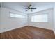 Bright bedroom featuring wood floors, a ceiling fan, white trim, and large windows with natural light at 115 Biscayne Nw Dr # F10, Atlanta, GA 30309