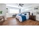 Bright bedroom with hardwood floors, a ceiling fan, and a cozy seating area near the window at 115 Biscayne Nw Dr # F10, Atlanta, GA 30309