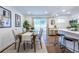 Light-filled dining area has a modern table, access to backyard, and kitchen bar seating at 115 Biscayne Nw Dr # F10, Atlanta, GA 30309