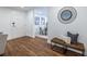 Stylish entryway with hardwood floors, a decorative mirror, and bench seating, leading to the dining area at 115 Biscayne Nw Dr # F10, Atlanta, GA 30309