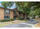 Exterior shot of the apartment building with brick and stone accents, lush landscaping, and an inviting entrance at 115 Biscayne Nw Dr # F10, Atlanta, GA 30309
