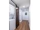 Hallway features a laundry closet with a barn door and modern lighting at 115 Biscayne Nw Dr # F10, Atlanta, GA 30309