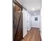 Hallway features a laundry closet with a stylish sliding barn door and modern recessed lighting at 115 Biscayne Nw Dr # F10, Atlanta, GA 30309