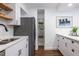 Well-lit kitchen with white cabinets, stainless steel appliances, and a charming pantry at 115 Biscayne Nw Dr # F10, Atlanta, GA 30309