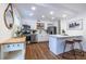 Modern kitchen has stainless appliances, white cabinetry, and an island with bar seating at 115 Biscayne Nw Dr # F10, Atlanta, GA 30309