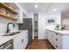 The contemporary kitchen features stainless appliances, white cabinetry, and hardwood floors at 115 Biscayne Nw Dr # F10, Atlanta, GA 30309