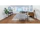 Bright living room featuring hardwood floors, a patterned rug, contemporary furniture, and stylish decor at 115 Biscayne Nw Dr # F10, Atlanta, GA 30309