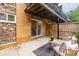 Stone and brick patio features an outdoor seating area with a small table, chairs and sliding glass door at 115 Biscayne Nw Dr # F10, Atlanta, GA 30309