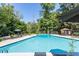 The community swimming pool offers a relaxing retreat with lounge areas, shade umbrellas, and manicured landscaping at 115 Biscayne Nw Dr # F10, Atlanta, GA 30309