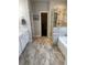 Bathroom featuring a tiled shower, tub, and vanity with marble countertops, providing a modern aesthetic at 2159 Holland Creek Ln, Buford, GA 30519