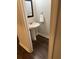 Stylish half bathroom with a pedestal sink and modern fixtures at 2159 Holland Creek Ln, Buford, GA 30519