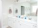 Bathroom featuring double sink vanity, large mirror and a soaking tub at 2159 Holland Creek Ln, Buford, GA 30519