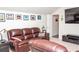 Bonus room with wall-mounted TV and leather seating at 2159 Holland Creek Ln, Buford, GA 30519