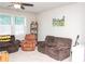 Bonus room with two sofas, a rolling chair, ceiling fan, and light-colored carpet at 2159 Holland Creek Ln, Buford, GA 30519
