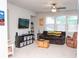 Bonus room with comfortable brown sofa, ceiling fan, large windows, and neutral-toned carpet at 2159 Holland Creek Ln, Buford, GA 30519