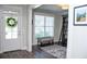 Foyer looking into office/library with a ladder, large bookcase and bench at 2159 Holland Creek Ln, Buford, GA 30519