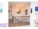 Hallway with artwork and dark wood bannister and floors at 2159 Holland Creek Ln, Buford, GA 30519