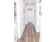 Hallway featuring dark wood floors and multiple doorways at 2159 Holland Creek Ln, Buford, GA 30519