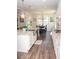 A pristine kitchen showcases stainless steel appliances, granite countertops, and wooden floors at 2159 Holland Creek Ln, Buford, GA 30519