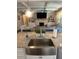 Modern kitchen with granite countertops and stainless steel sink overlooking the fireplace and living area at 2159 Holland Creek Ln, Buford, GA 30519