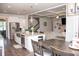 Open-concept kitchen with stainless steel appliances, an island with seating, and hardwood floors at 2159 Holland Creek Ln, Buford, GA 30519