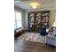 Cozy living room featuring custom built-in bookshelves and ample seating space at 2159 Holland Creek Ln, Buford, GA 30519