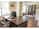 Bright office space showcasing dark wood floors, large desk, and adjacent bookcase at 2159 Holland Creek Ln, Buford, GA 30519