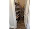 Organized walk-in pantry featuring wooden floors and ample shelving space for storage at 2159 Holland Creek Ln, Buford, GA 30519